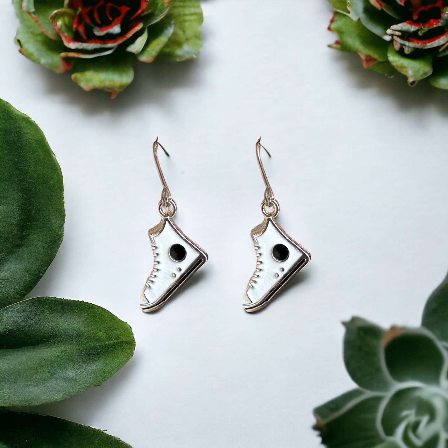 Running Shoe Charm Drop Earrings with a titanium hook on a white background . white