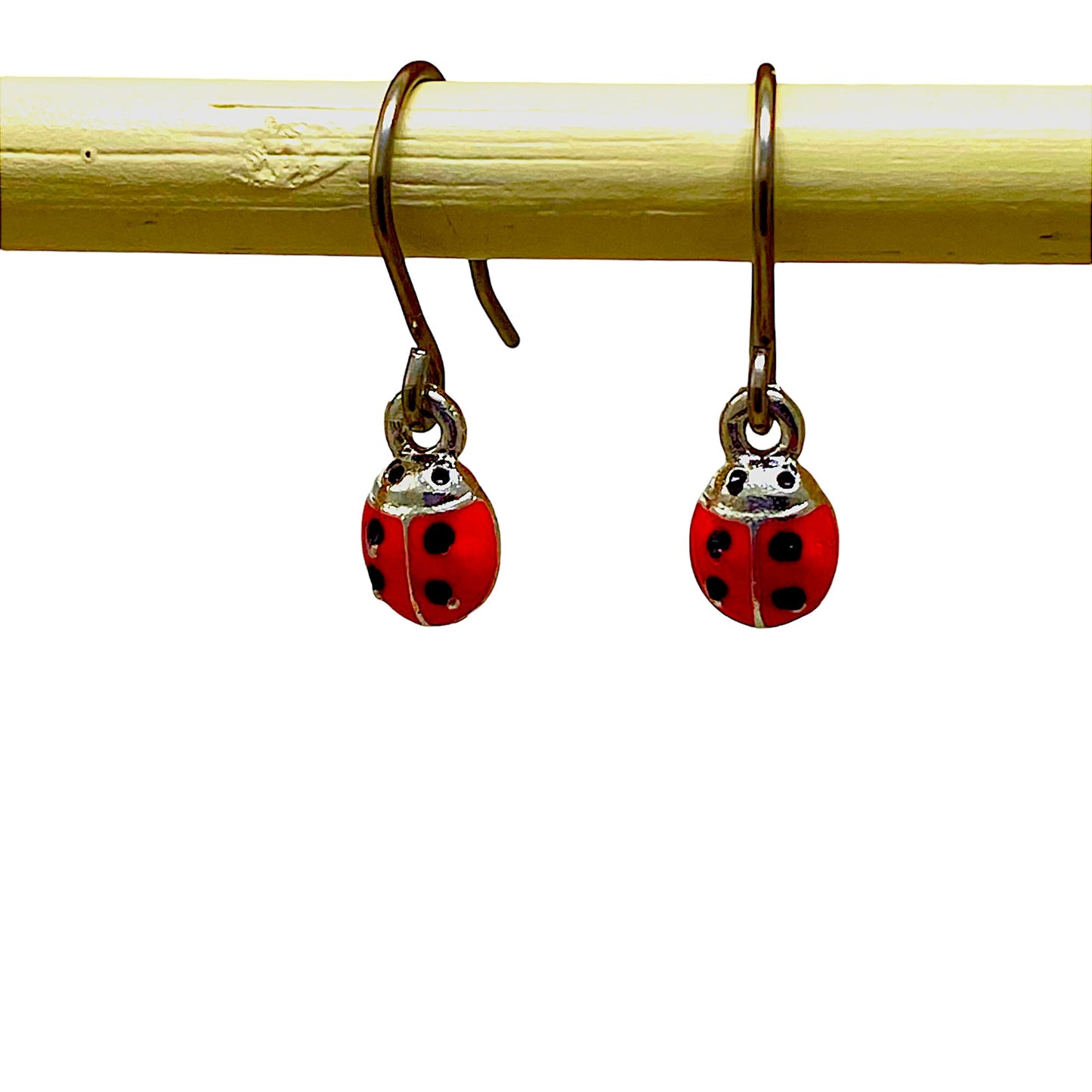 Ladybug earrings with a titanium hook on a white background