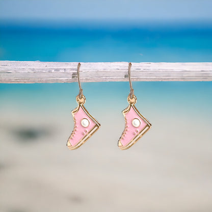 Running Shoe Charm Drop Earrings with a titanium hook on a white background . pink