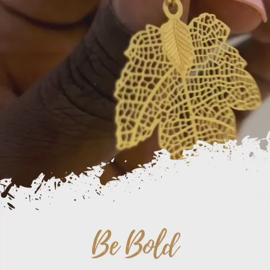 Maple leaf earrings. Detachable earrings for a truly hypoallergenic jewellery on a white young woman Maple leaf earrings on a black hand