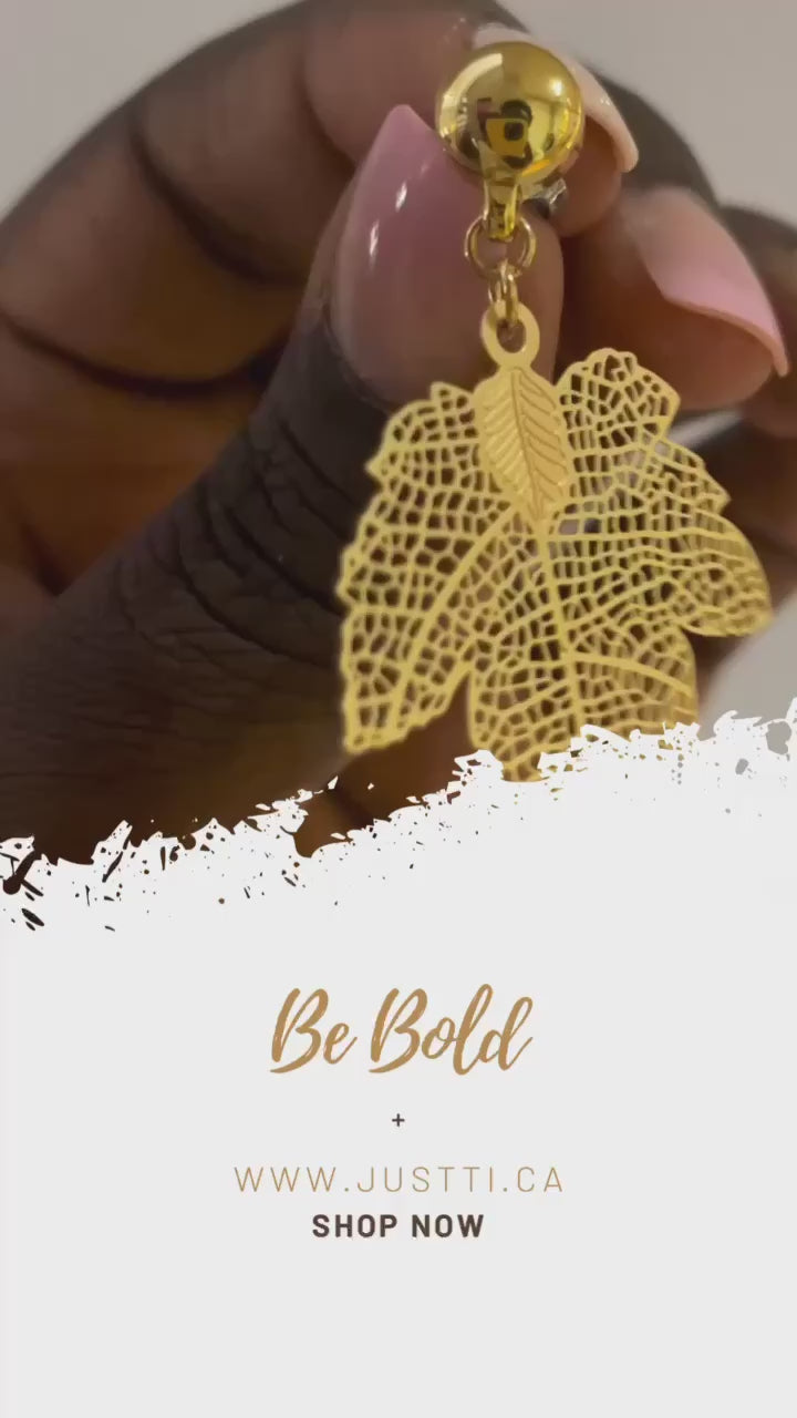 Maple leaf earrings. Detachable earrings for a truly hypoallergenic jewellery on a white young woman Maple leaf earrings on a black hand