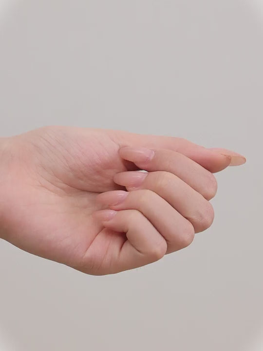 Close-up of an woman wearing a siltitanium hoop earring and in her hand