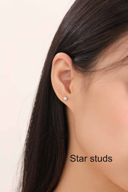 Star Studs. Titanium Studs with titanium backs. These studs shown on a white woman. lettering