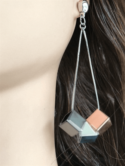 TI-GO Cubed earrings. Magnetic titanium interchangeable earring system. Detachable earrings for a truly hypoallergenic jewellery on a white young woman.