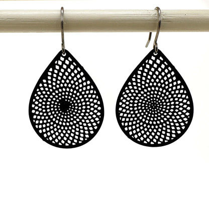 Black teardrop earrings with titanium hook. on a white background