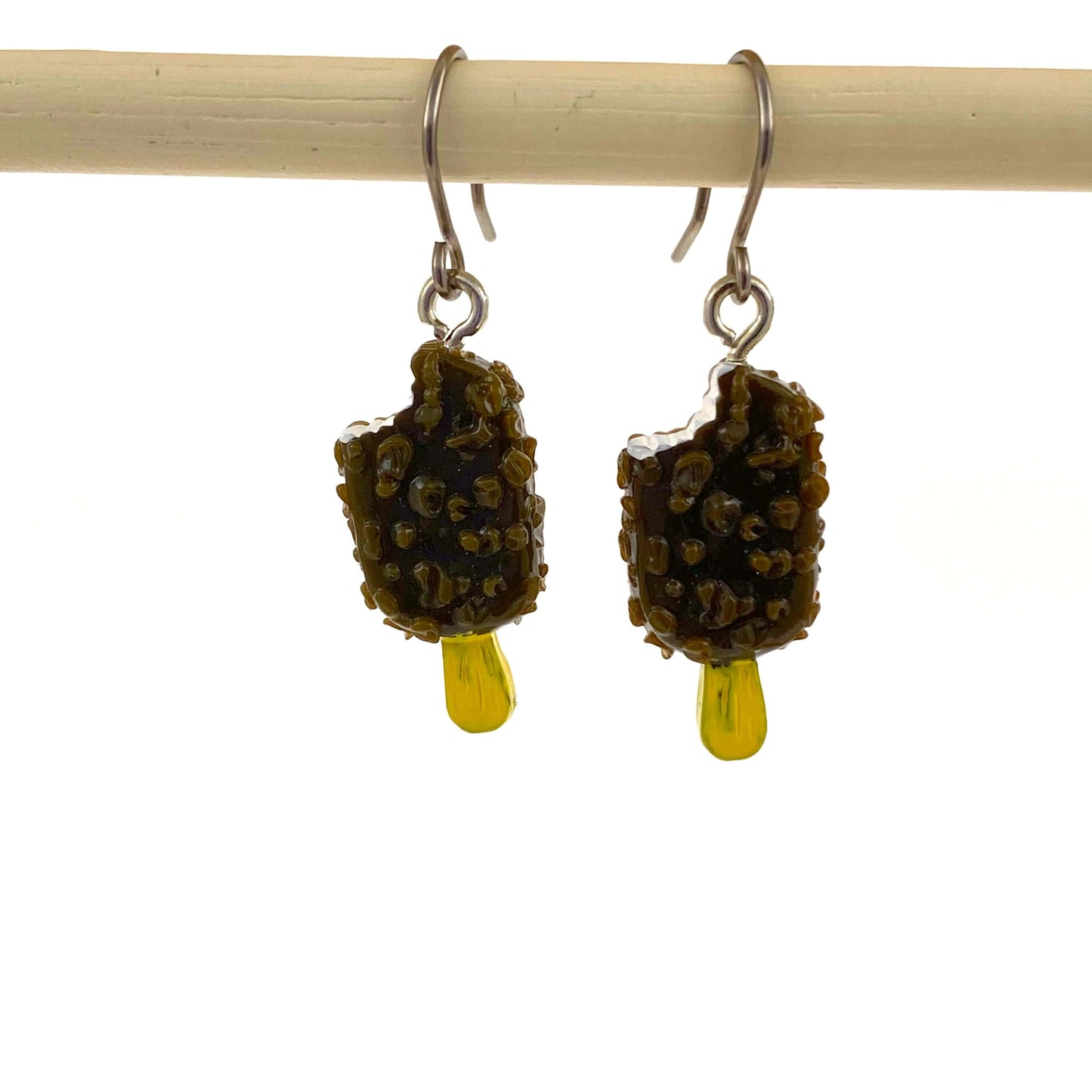 Popsicle earrings with a titanium hook on a white background.  brown