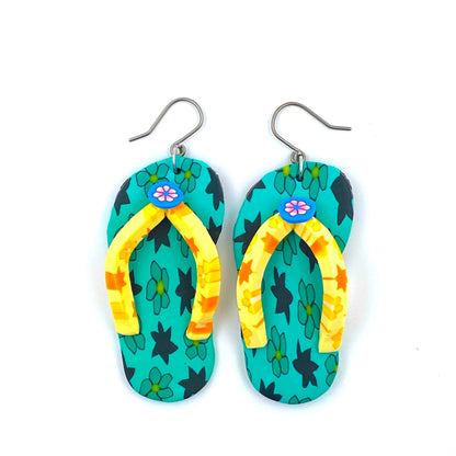 Flip flop earrings in green with a titanium hook on a white background