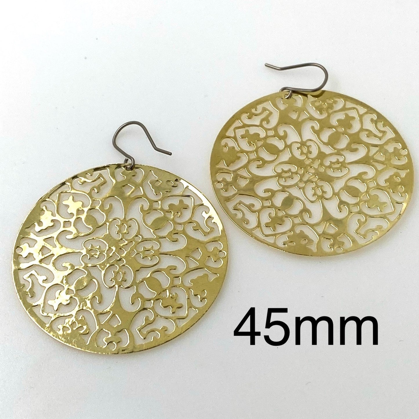 Gold disc earring 45mm titanium on a white background