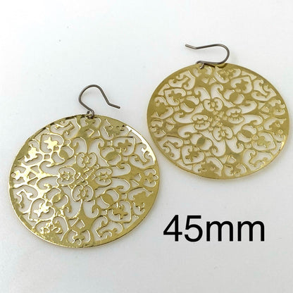 Gold disc earring 45mm titanium on a white background