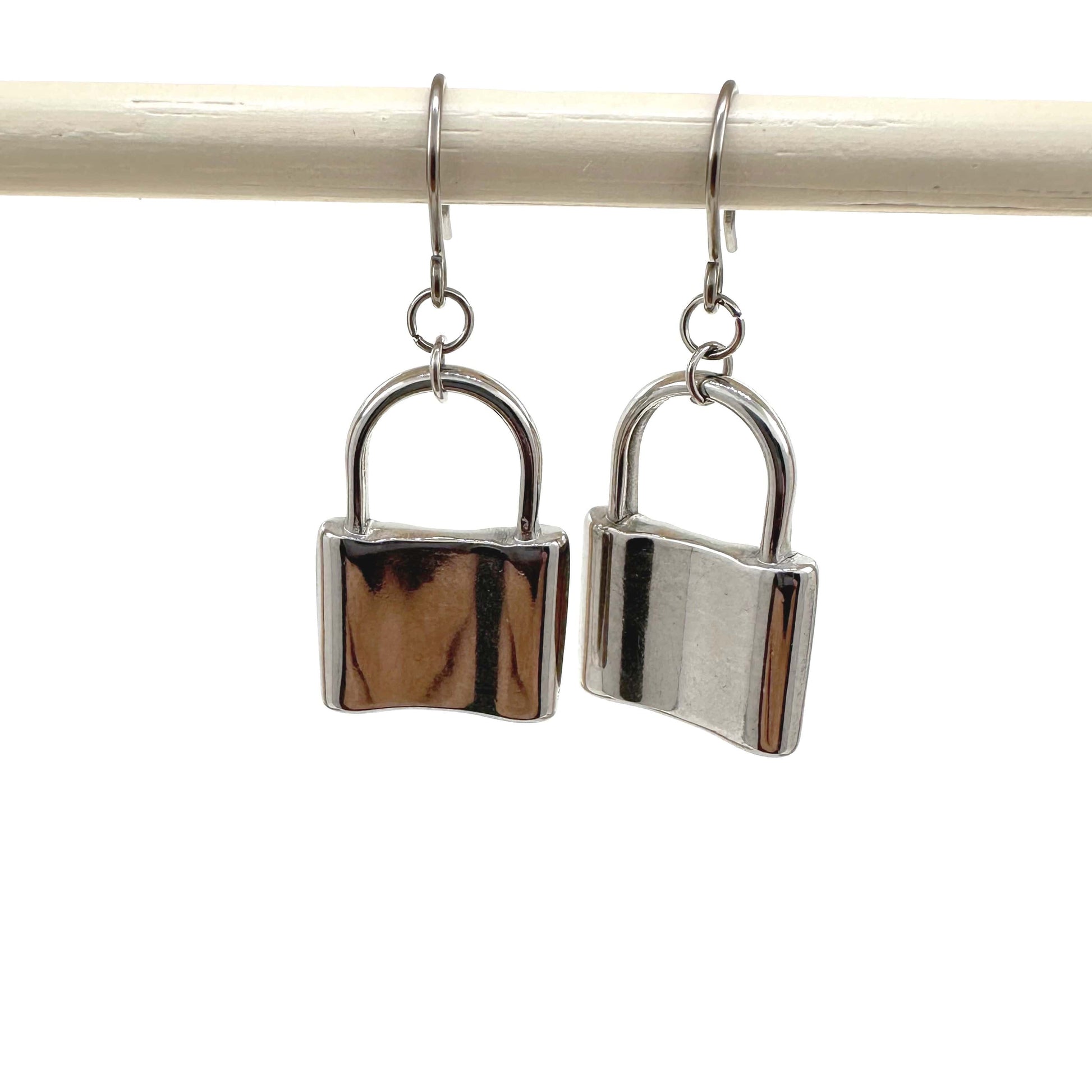 Large silver padlock earringswith a titanium hook on a white background