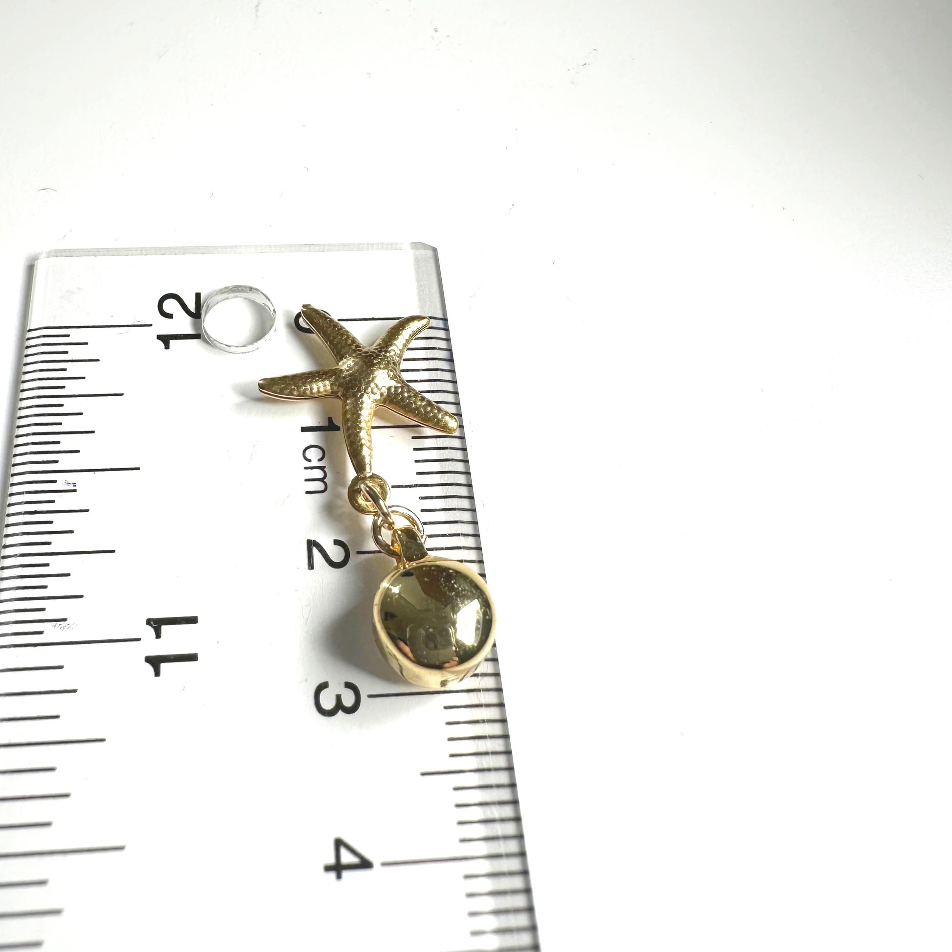 Starfish Charm earrings. Detachable earrings for a truly hypoallergenic jewellery on a ruler background