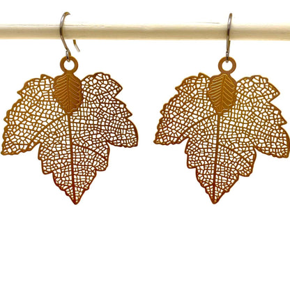 Maple leaf gold leaf earring with a titanium hook on a white background