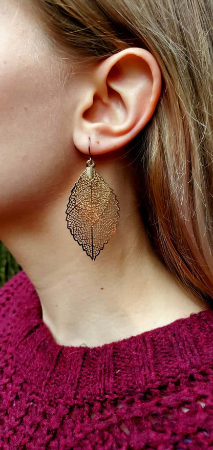 Rose gold leaf earring with titanium hook on Emily Glover