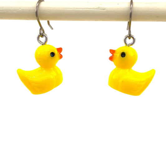 Rubber ducky earrings with a titanium hook on a white background