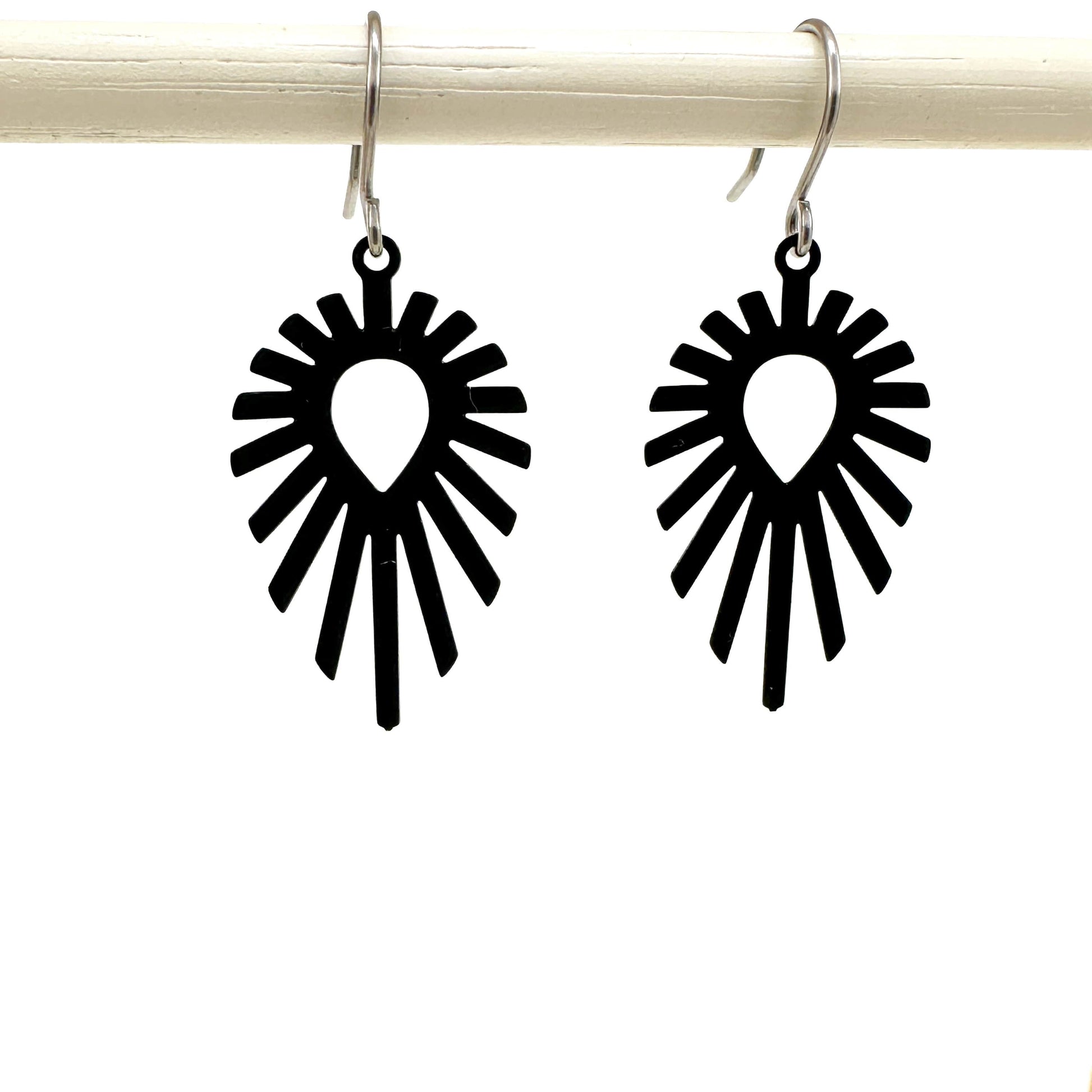 Shine teardrop black earrings with a titanium hook on a white background