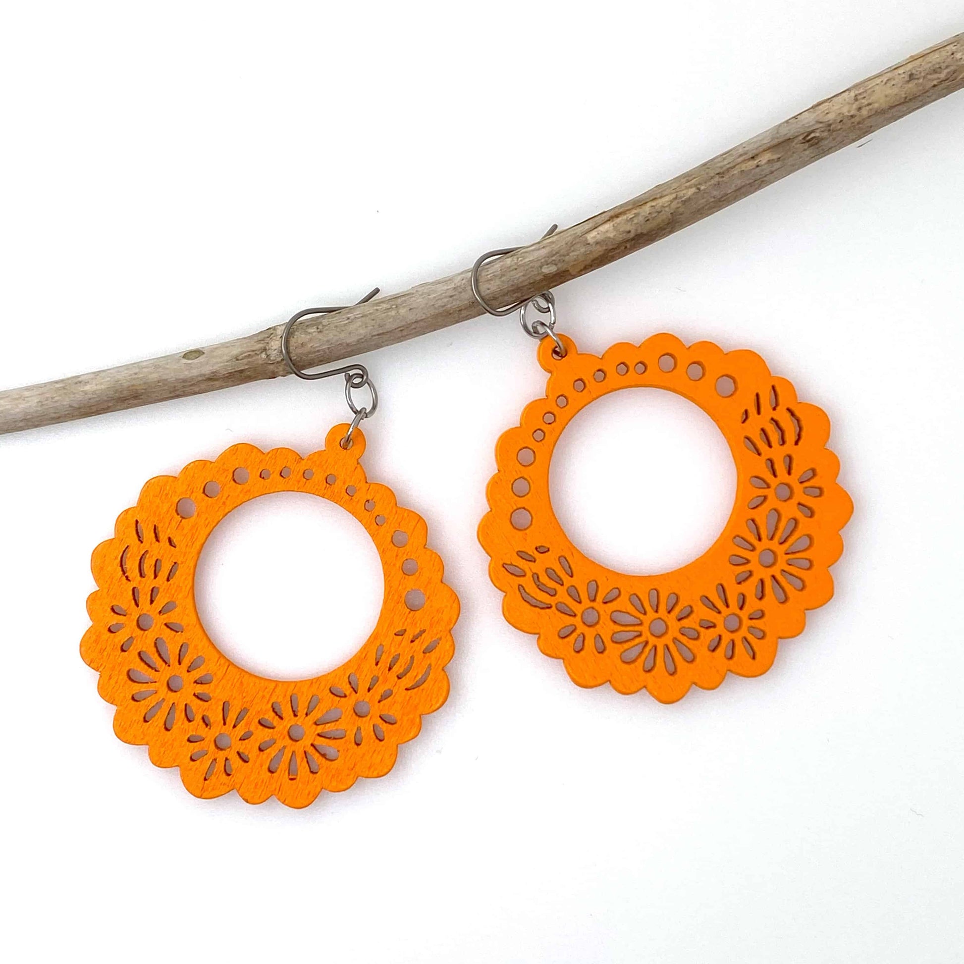 Wooden Floral earrings on a white background. orange