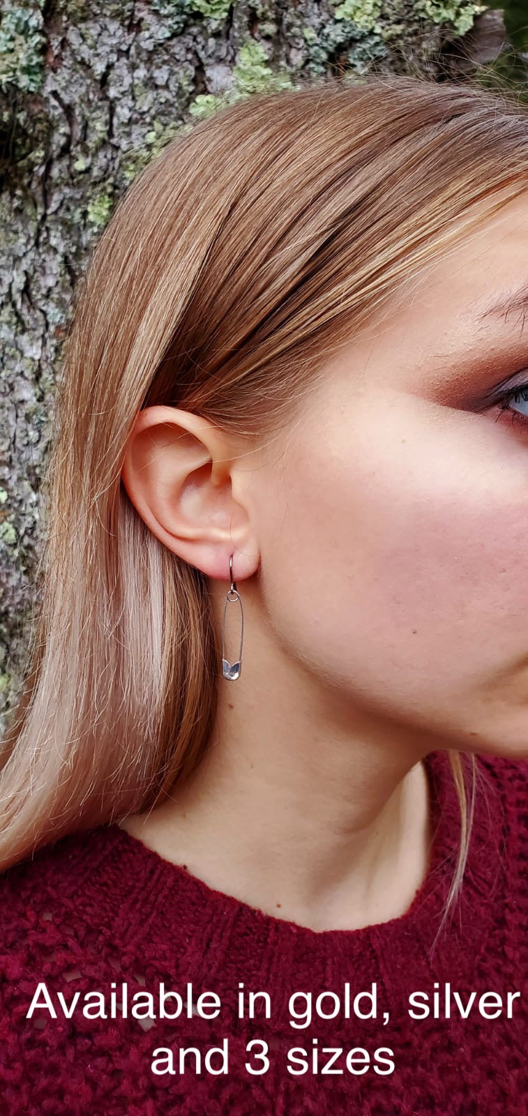 SafetyPin earrings with a titanium hook on a white young woman. Emily