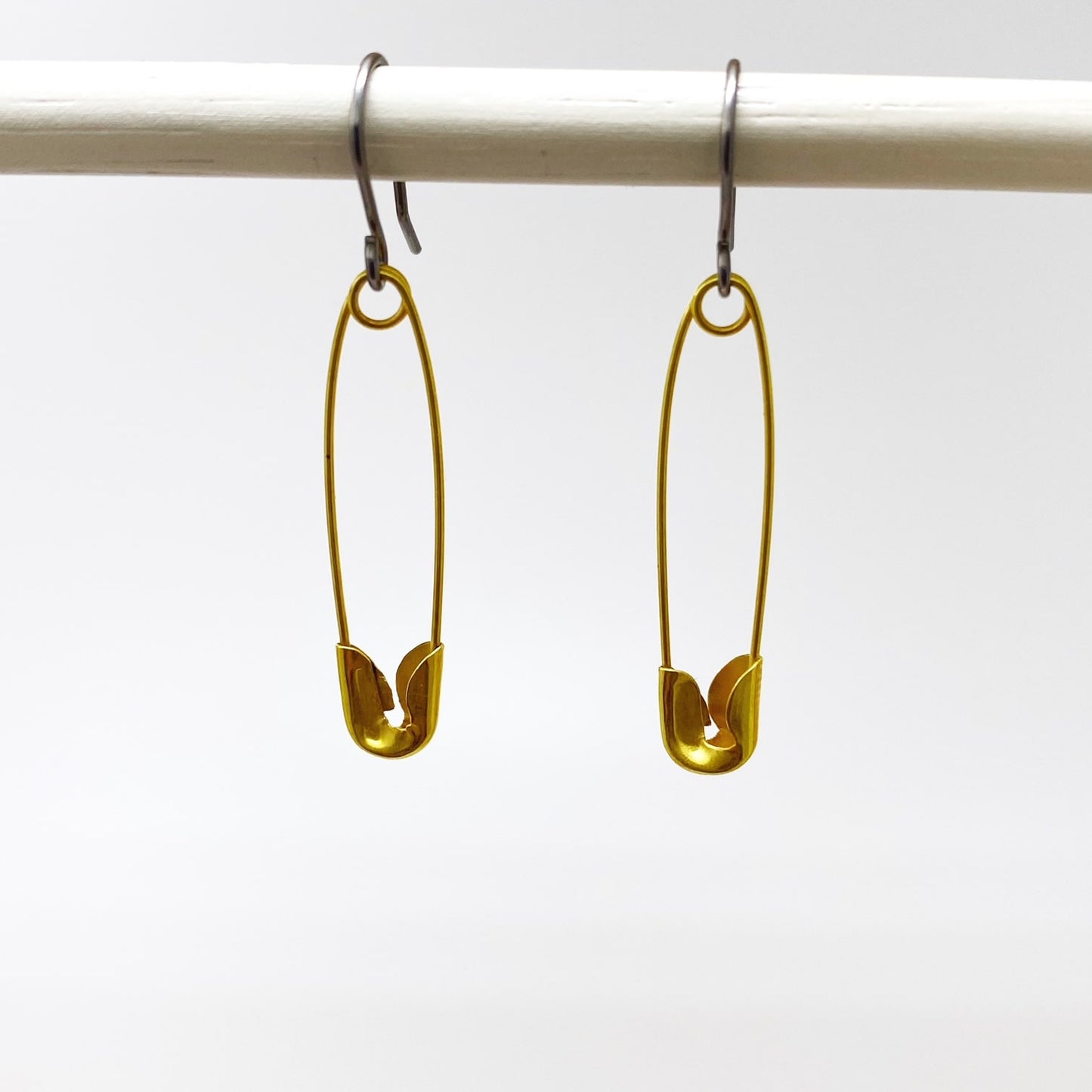 SafetyPin earrings with a titanium hook on a white background