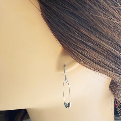 SafetyPin earrings with a titanium hook on a white young woman.